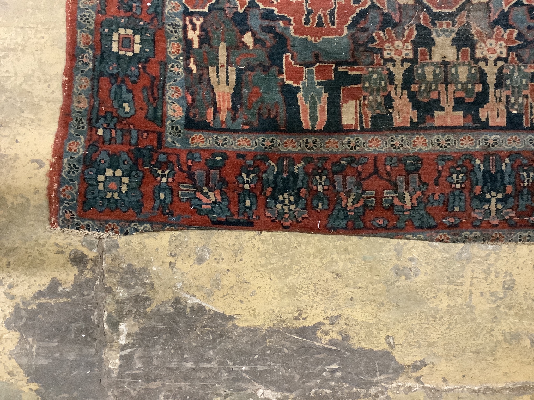An antique Persian blue ground rug, woven with birds within a garden, 170 x 120cm